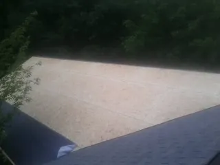 New OSB roof sheathing installed beside an existing shingle roof in Wichita Falls