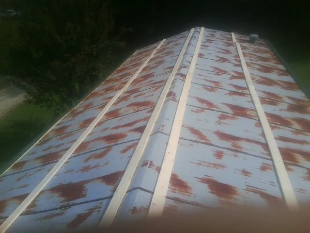 Rusted metal roof panels with new wood purlins before replacement — Storm Damage Roof Repair in Wichita Falls by Roofing Brothers